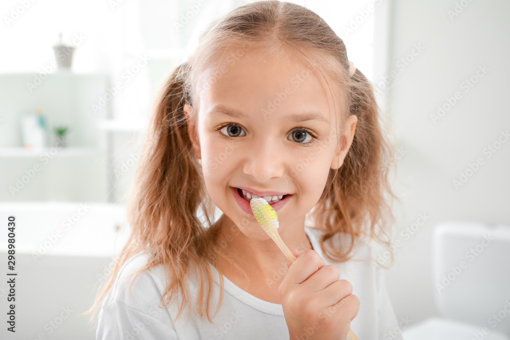 Little girl brushing teeth in bathroom Little girl brushing teeth in bathroom