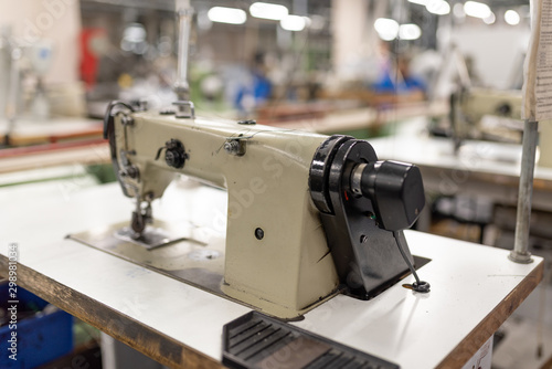 Industrial sewing machine in the work shop. Shoe manufacturing.