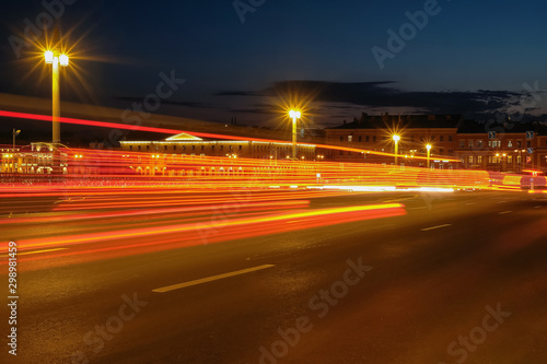 traffic on the highway at night. light trails in the road. yellow and red lights in night city road. the way of the car lights