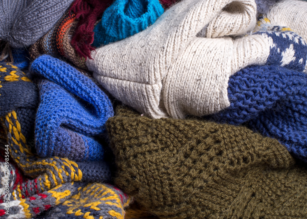 Fototapeta Heap of multi-colored knitted warm clothes are ready for cold autumn and winter.