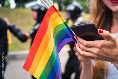 Hand hold a gay lgbt flag at LGBT gay pride parade festival