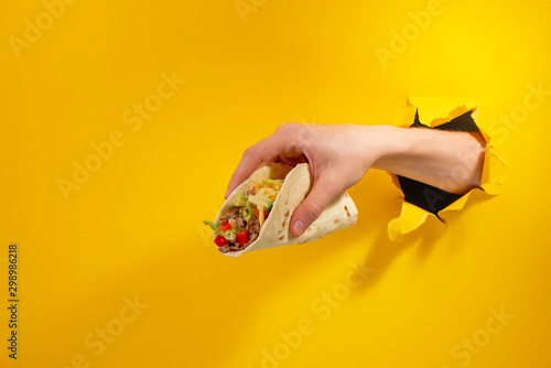 Hand giving a taco