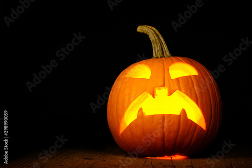 Scared Jack O Lantern halloween pumpkin with candlelight inside
