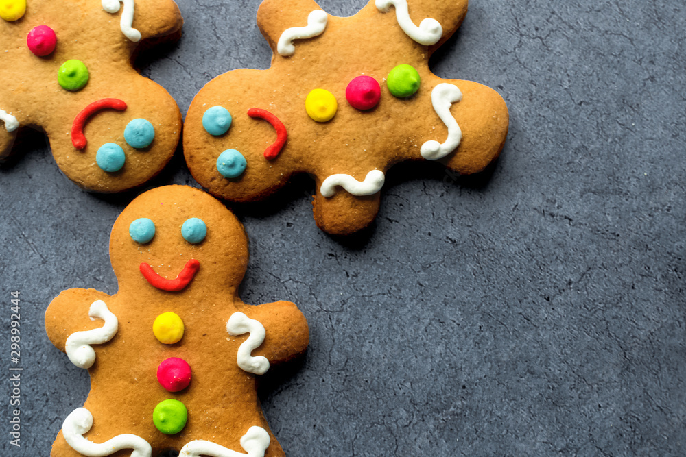 Delicious Christmas gingerbread men.Christmas baking ingredients and supplies on dark background.Postcard. Congratulation.Cooking. Christmas cookie man.Christmas minimalism.close up.copy space Delicious Christmas gingerbread men.Christmas baking ingredients and supplies on dark background.Postcard. Congratulation.Cooking. Christmas cookie man.Christmas minimalism.close up.copy space