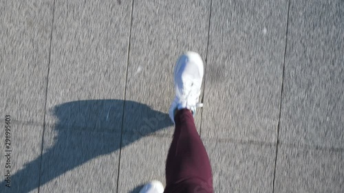 Top view women's feet go down the road