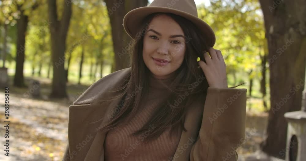 Gorgeous Caucasian woman in elegant hat spinning in the autumn park. Charming European woman with pleasant smile and brown hair having fun outdoors. Cinema 4k footage ProRes HQ. Gorgeous Caucasian woman in elegant hat spinning in the autumn park. Charming European woman with pleasant smile and brown hair having fun outdoors. Cinema 4k footage ProRes HQ.