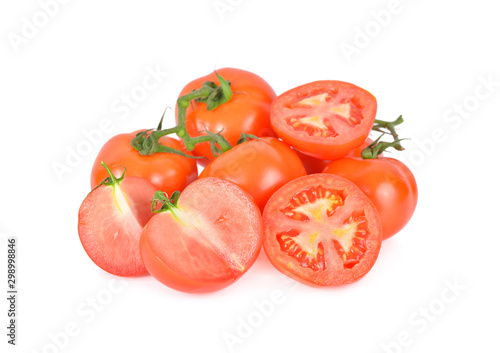 whole and cut tomatoes with stem on white background