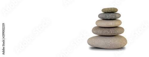 Stacked rounded stones isolated on white background with copy space. Zen concept.