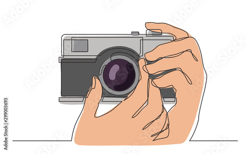 continuous line drawing of hand holding photo camera making pictures