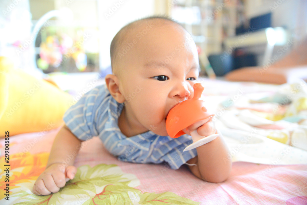 Cute little Asian baby boy chewing teething Cute little Asian baby boy chewing teething
