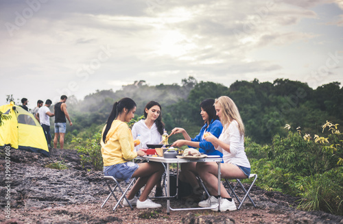 Group of diversity friends cooking food for breakfast at outdoor together,Enjoying camping concept