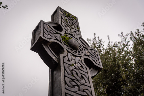 Wonderful embossed Celtic stone cross, full of details and textures in its elaborate carvings and lichen growing. photo