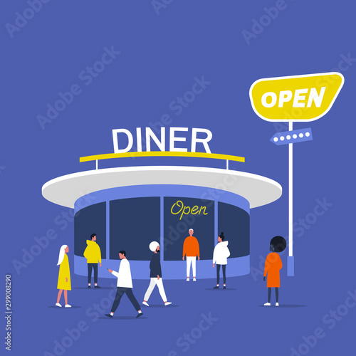 People walking and standing in front of the old fashioned American diner round pavilion with neon signs