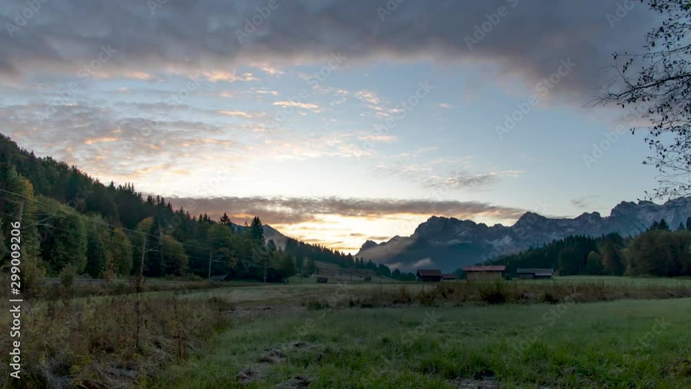 Zoom out timelapse of morning landscape on field next to a railway with some fog in the distance and beautiful lit clouds in early autumn. Steady perspective. Zoom out timelapse of morning landscape on field next to a railway with some fog in the distance and beautiful lit clouds in early autumn. Steady perspective.