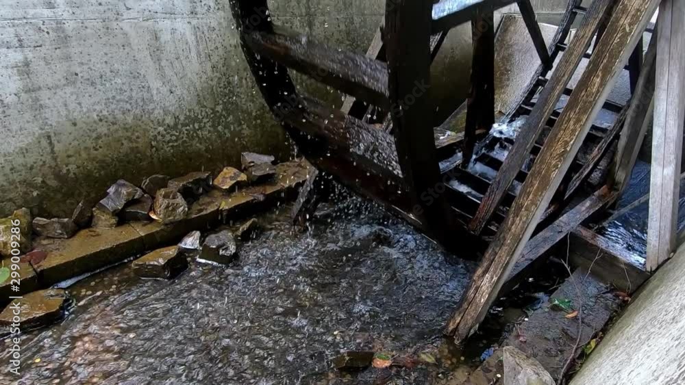 Wooden Water Mill Wheel Spinning. Slowmotion Zoom In of a Spinning Water Mill. Wooden Water Mill Wheel Spinning. Slowmotion Zoom In of a Spinning Water Mill.