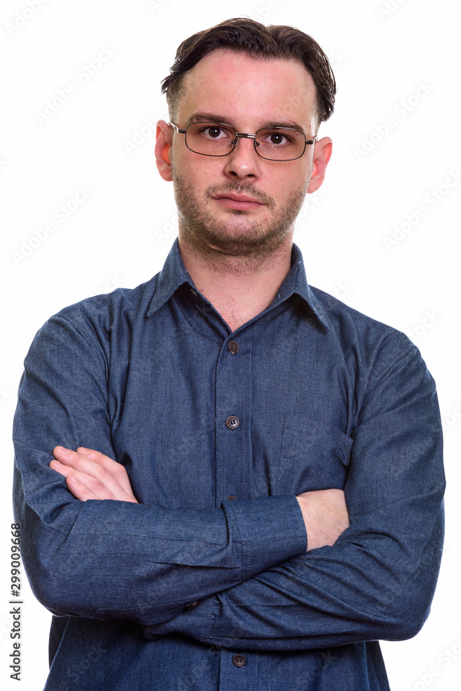 Close up of formal young man wearing eyeglasses with arms crosse Close up of formal young man wearing eyeglasses with arms crosse