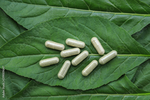 Herbal supplement medicine on herb leaf for healthy eating 