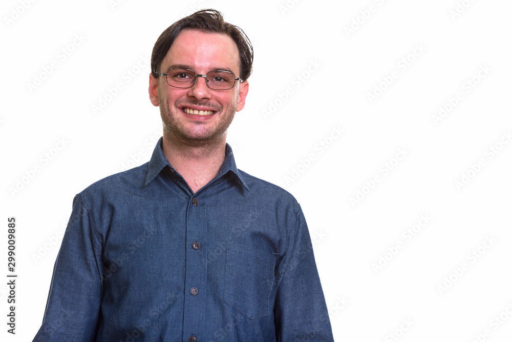 Fototapeta premium Studio shot of formal young happy man smiling while wearing eyeg