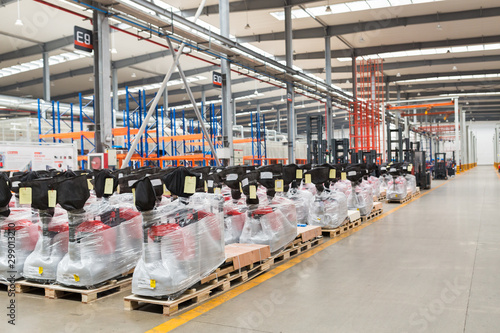 Large hangar warehouse of industrial and logistics companies. New pallet trucks in stock. industry space and hardware box for delivery, business logistic distribution storage cargo concept.