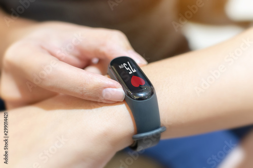 Close up image hand of male using smart watch with health app checking measure heart rate at normal levels