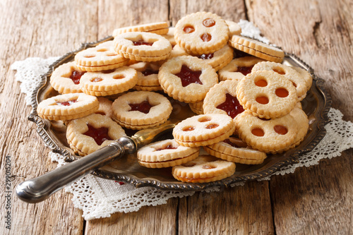 Christmas shortbread Linzer cookies with jam filling close-up on a plate on the table. Horizontal photo