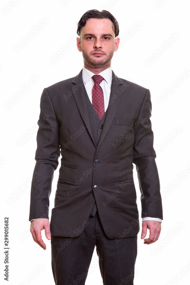 Studio shot of young businessman looking at camera Studio shot of young businessman looking at camera