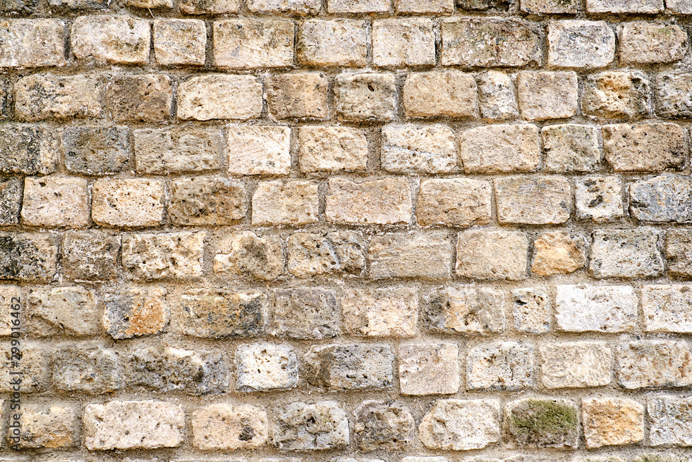 Background from a rough brown natural stone wall Background from a rough brown natural stone wall