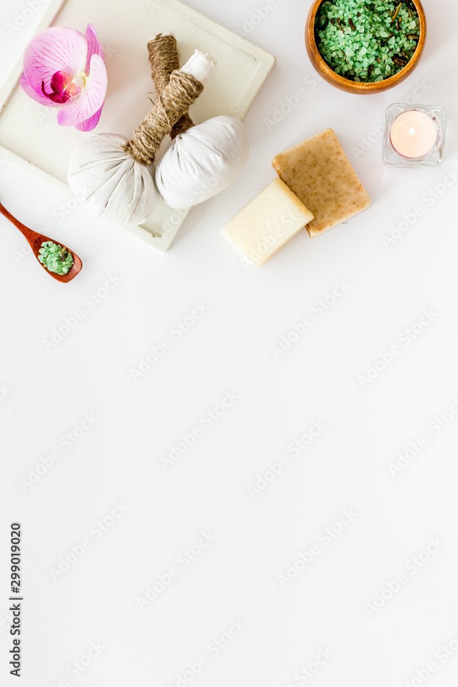 Preparing for massage in spa salon - with candles and orchids - white background top view frame copy space Preparing for massage in spa salon - with candles and orchids - white background top view frame copy space