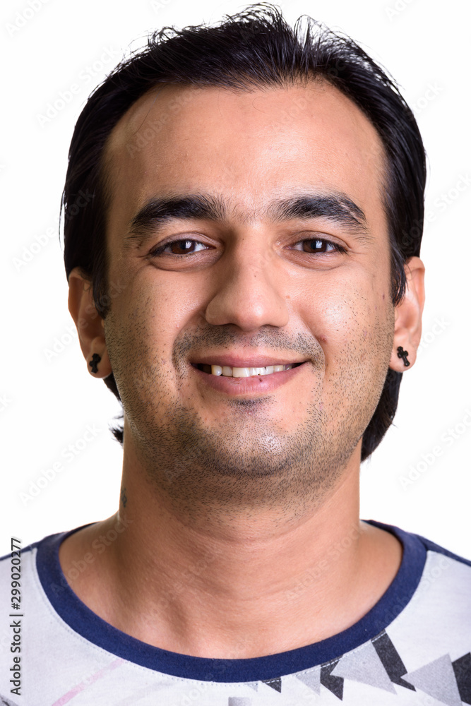 Face of happy Persian man smiling and looking at camera Face of happy Persian man smiling and looking at camera