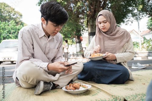 portrait of couple eat traditional food of indonesia is nasi rames on the tikar