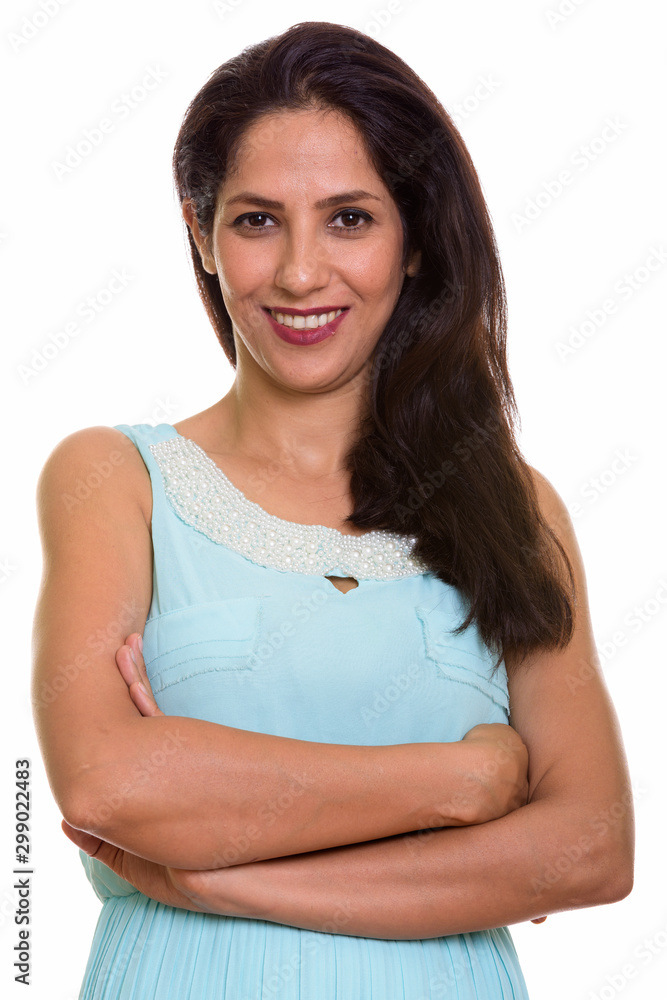 Close up of happy Persian woman smiling with arms crossed Close up of happy Persian woman smiling with arms crossed