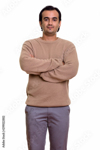 Portrait of Persian man wearing sweater with arms crossed © Ranta Images