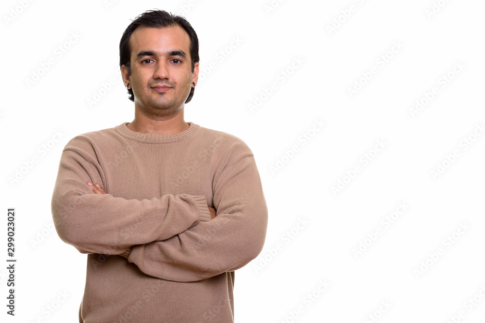 Portrait of Persian man wearing sweater with arms crossed Portrait of Persian man wearing sweater with arms crossed