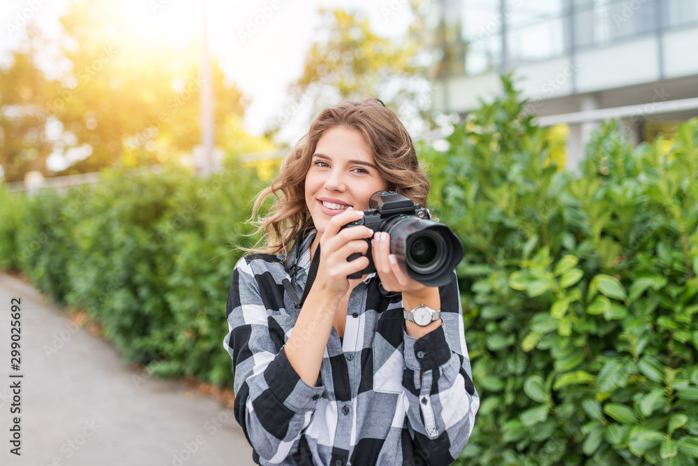 Young woman getting ready to take picture with digital camera outdoors. Young woman getting ready to take picture with digital camera outdoors.