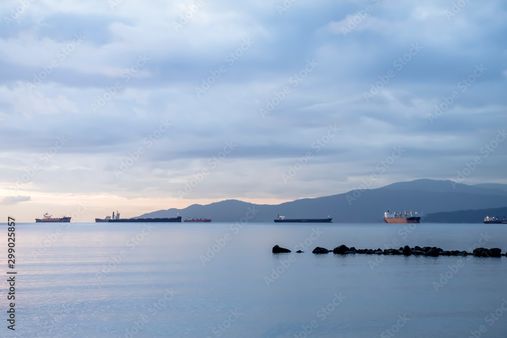 Blurry scene of ocean at the sunset with cloudy and ship as background. Concept of to calm yourself down from stress, relax, depress and clean up mind with clear and clean nature.