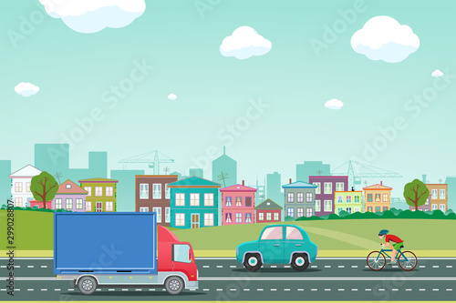 Highway with cars on the background of the city with houses