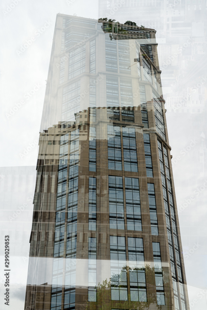 Fototapeta premium Portrait Of Tall Corporate Buildings In Multiple Exposure
