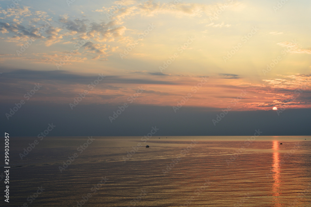 Obraz premium Sunrise over the sea in the early morning near the coast of Sicily, Italy