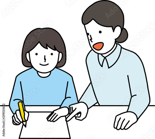 先生に勉強を教えてもらう女の子