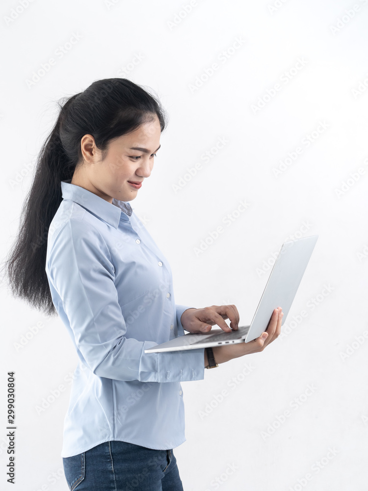 Happy Asian woman using laptop with white wall,lifestyle concept. Happy Asian woman using laptop with white wall,lifestyle concept.
