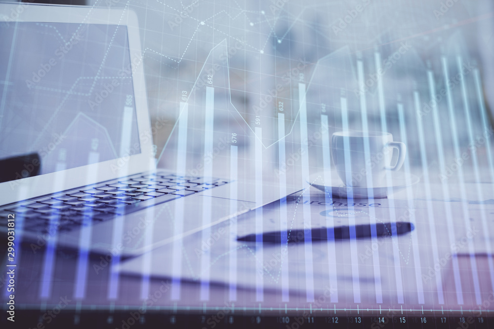Forex graph hologram on table with computer background. Double exposure. Concept of financial markets. Forex graph hologram on table with computer background. Double exposure. Concept of financial markets.