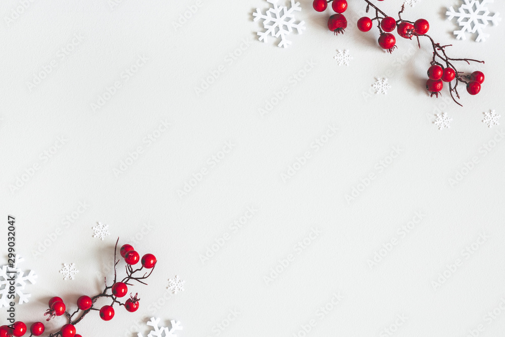Christmas or winter composition. Snowflakes and red berries on gray background. Christmas, winter, new year concept. Flat lay, top view, copy space - obrazy, fototapety, plakaty 