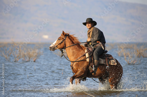 cowboy and horse at first light,mountain, river and lifestyle with natural light background	