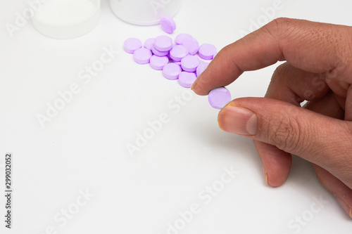 finger holded medical drug before oral take in medical healthcare consumption concept with copy space