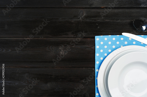 Table setup with plates on dark wooden background