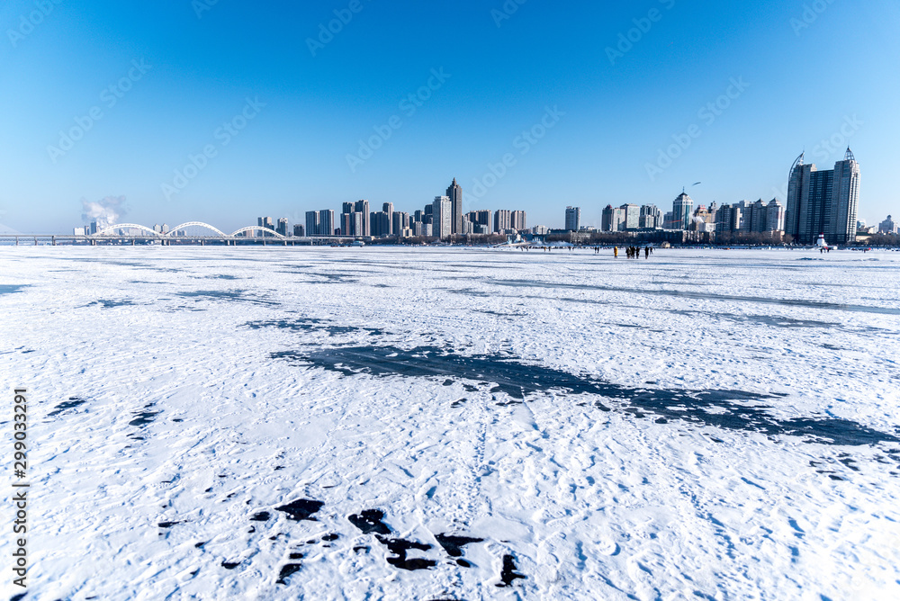 In Winter river the turns into frozen, People can walk down and arrange activities on the river in Harbin China