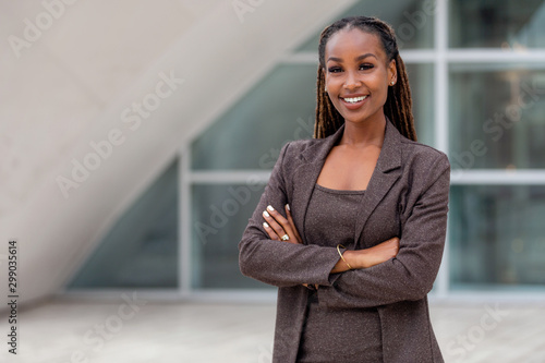 Beautiful african american business woman portrait, arms folded, confident happy CEO