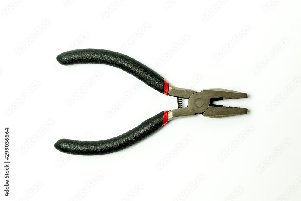 Close up of new pliers with plastic rubber handles black and red color isolated on white background.Electricial tool.Top view. Close up of new pliers with plastic rubber handles black and red color isolated on white background.Electricial tool.Top view.