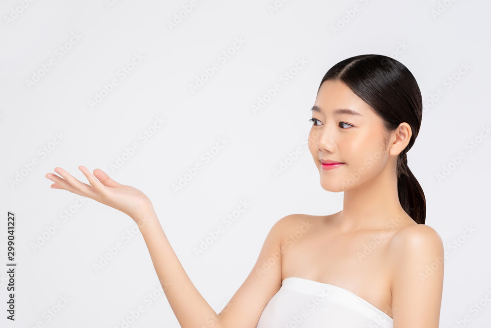 Young beautiful smiling Asian woman expressing open hand for beauty concepts Young beautiful smiling Asian woman expressing open hand for beauty concepts