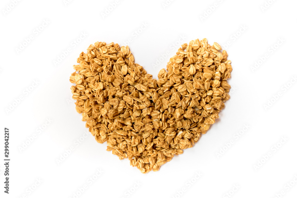 Close up of uncooked rolled oats (oat flakes) shape form heart isolated on white background. Concept :Love healthy food ,Vegan food ,Raw food ,Valentine 's day. Close up of uncooked rolled oats (oat flakes) shape form heart isolated on white background. Concept :Love healthy food ,Vegan food ,Raw food ,Valentine 's day.